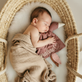 Baby with beige muslin blanket and Maline goose comforter