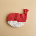 Whale crinkle toy with bright coral-red waffle musselin fabric